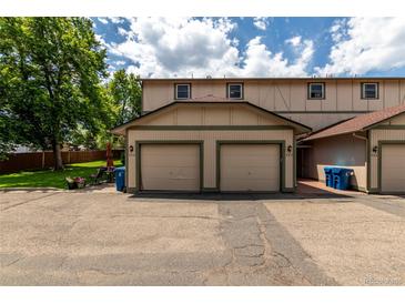 Charming exterior view of the home showcasing the attached two-car garage at 902 S Yukon St, Lakewood, CO 80226