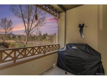 Cozy outdoor patio features a grill and golf decor with scenic views of the golf course at 11962 W Long Cir # 103, Littleton, CO 80127