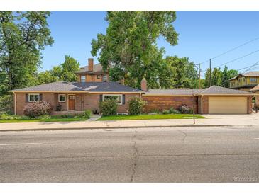 Charming brick home with mature trees, manicured landscaping, and a two-car garage offers delightful curb appeal at 3530 E 8Th Ave, Denver, CO 80206
