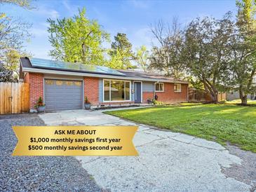 Charming red brick home with a well-manicured lawn and solar panels for energy savings at 2235 Edgewood Dr, Boulder, CO 80304