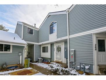 Inviting townhome exterior with blue siding, white trim, and a charming wreath on the front door at 266 S Nome St, Aurora, CO 80012