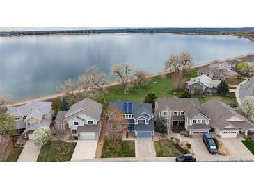 Aerial view of lakeside homes featuring manicured lawns and mature trees at 4814 S Upham Ct, Littleton, CO 80123