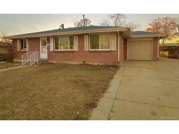 Brick ranch house with attached garage and yard at 8511 Franklin Dr, Denver, CO 80229