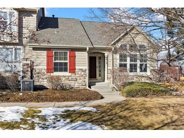 Attractive exterior of a two-story home with red shutters and stone accents at 6415 Trailhead Rd, Highlands Ranch, CO 80130
