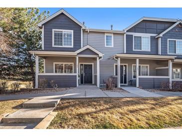 Charming townhome with inviting front porch and well-maintained landscaping at 19247 E Gunnison Pl # 104, Aurora, CO 80017