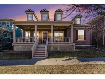 Charming home exterior with a welcoming front porch and stylish architectural details at sunset at 2730 Hanover N St, Denver, CO 80238