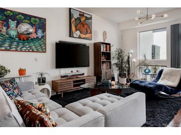 Bright living room showcasing unique furniture, stylish décor, and expansive windows at 2460 W 29Th Ave # 104, Denver, CO 80211