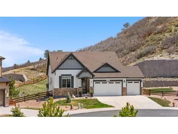 Charming two-story home features a three-car garage and beautifully landscaped front yard with mountain views at 2065 Sage Grouse Way, Castle Rock, CO 80109