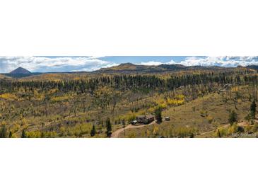 Panoramic view of the property, showcasing a charming home nestled amidst a serene landscape with colorful foliage at 97 Hedges Cir, Sedalia, CO 80135