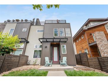 Modern home with a two-tone exterior, covered porch, and rooftop deck at 4557 Stuart St, Denver, CO 80212