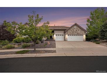 Charming single-story home featuring a well-manicured front yard and a spacious three-car garage at 5924 S Kittredge St, Centennial, CO 80016