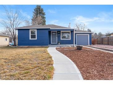 Charming blue home with landscaped front yard and sidewalk leading to the front door at 3080 S Eudora St, Denver, CO 80222