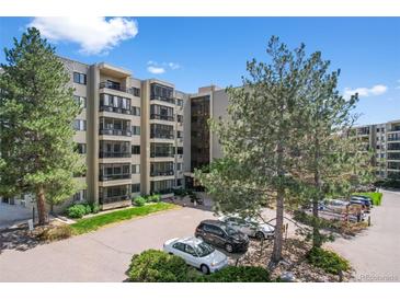Modern condo building showcasing a manicured entrance, mature trees, and well-maintained landscaping at 13850 E Marina Dr # 304, Aurora, CO 80014