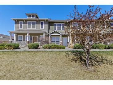 Inviting townhomes with front porch, tidy lawns, and well-kept landscaping create great curb appeal at 15612 E 96Th Way # 9B, Commerce City, CO 80022