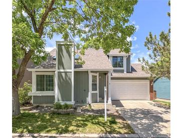 Charming two-story home with a well-maintained lawn and a two-car garage at 944 E Lily Ct, Highlands Ranch, CO 80126