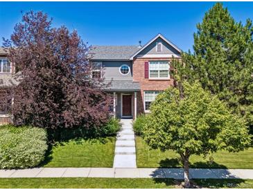 Charming two-story home with a well-manicured lawn and inviting curb appeal at 12427 James Ct, Broomfield, CO 80020