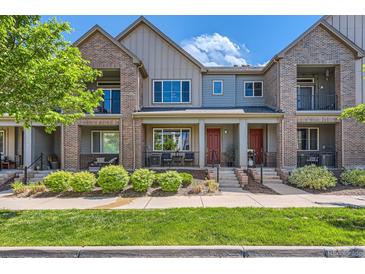 Attractive brick and siding townhome with landscaped yard and inviting front porches in a desirable neighborhood at 504 E Dry Creek Pl, Littleton, CO 80122
