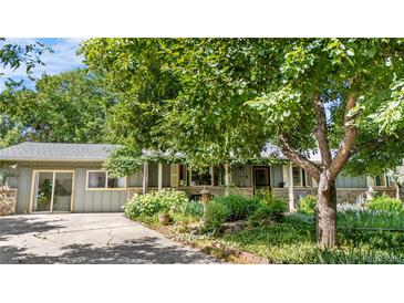 Charming single-story home with lush, mature landscaping and a welcoming front porch at 1315 Tipperary St, Boulder, CO 80303