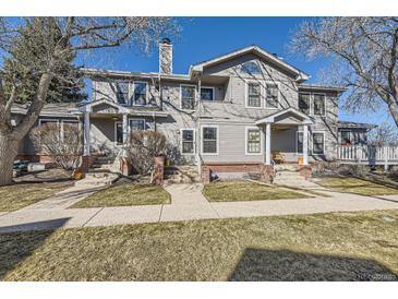 Charming two-story home with inviting front porches and well-maintained landscaping under a clear blue sky at 624 S Depew St # C, Lakewood, CO 80226