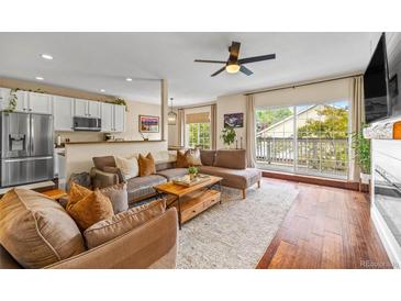 Inviting living room featuring a comfortable sectional sofa and a seamless transition to the kitchen area at 6813 W Yale Ave, Lakewood, CO 80227