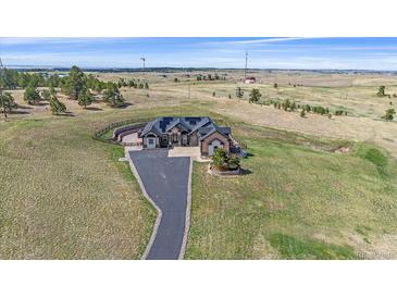 Expansive aerial view showcases this amazing home's setting and beautiful lawn at 575 Howling Cir, Elizabeth, CO 80107