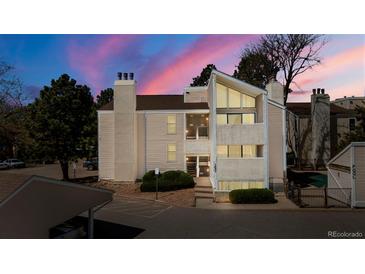 Charming condo exterior with a well-maintained lawn and beautiful sunset sky at 3662 S Granby Way # J05, Aurora, CO 80014