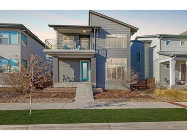 Charming two-story home featuring modern architecture and a welcoming front porch at 1365 W 67Th Pl, Denver, CO 80221