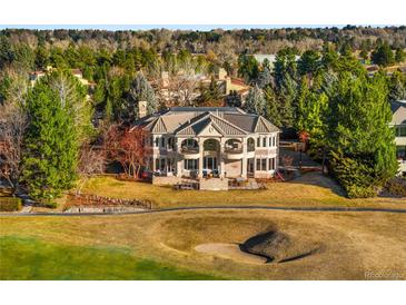 Stunning estate home overlooking the lush golf course with manicured lawn and mature landscaping at 73 Glenmoor Dr, Cherry Hills Village, CO 80113