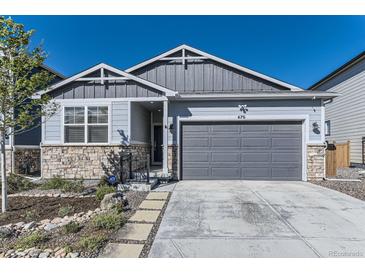Charming single-Gathering home with stone accents, landscaped front yard, and a two-car garage at 476 Silver Rock Trl, Castle Rock, CO 80104