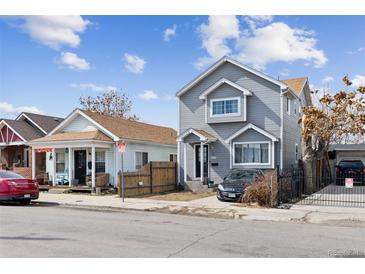 Charming two-story home featuring gray siding, double-pane windows, and a well-manicured front yard at 4445 Pearl St, Denver, CO 80216