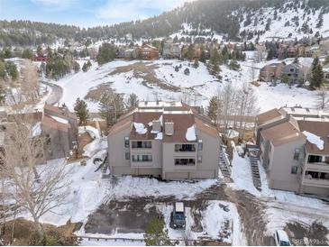 Complex nestled in a wooded area with mountain views at 23694 Pondview Pl # B, Golden, CO 80401