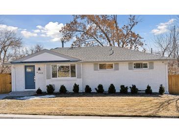 Charming ranch-style home with fresh exterior paint, blue door, new roof, and updated landscaping at 2408 E Cresthill Ave, Centennial, CO 80121