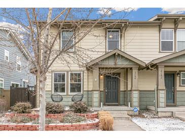 Charming townhouse featuring a covered front porch, well-kept landscaping, and neutral color palette at 2184 Willow Ct, Denver, CO 80238