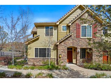 Charming home with a stone and siding exterior, manicured landscaping, and a welcoming front entrance at 10103 Bluffmont Ln, Lone Tree, CO 80124