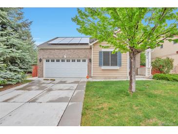 Charming single-Gathering home features a two-car garage, solar panels, and well-maintained lawn at 18619 E Vassar Dr, Aurora, CO 80013