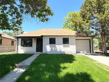 Charming single-story home with a well-manicured lawn, attached garage, and appealing neutral exterior paint at 2895 Poplar St, Denver, CO 80207