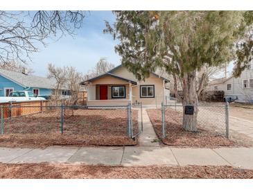 Charming single-story home with a fenced front yard and a red front door at 2056 Fulton St, Aurora, CO 80010