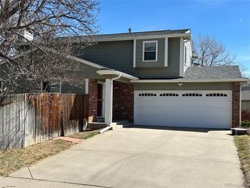 Charming two-story home with a two car garage, brick accents, and a well-maintained front yard at 5612 S Lansing Ct, Englewood, CO 80111