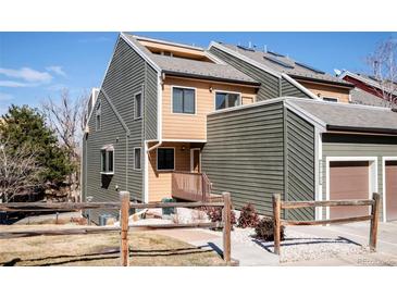 Charming multi-level townhouse featuring a fenced yard, inviting entryway, and a blend of wood and siding accents at 2885 Springdale Ln, Boulder, CO 80303