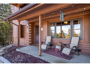 Cozy covered porch offers comfortable seating and scenic views of the surrounding landscape at 636 Chute Rd, Golden, CO 80403