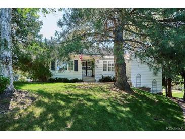 Charming home featuring a well-manicured lawn and inviting curb appeal shaded by mature trees at 4675 S Yosemite St # 205, Denver, CO 80237