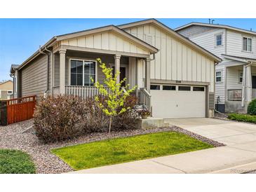 Charming home featuring a cozy front porch, attached two-car garage, and well-maintained landscaping at 3548 Swabuck Pl, Castle Rock, CO 80109