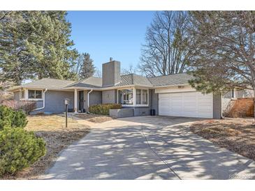 Charming single-story home with a brick facade, attached garage, and well-maintained landscaping at 2 N Jasmine St, Denver, CO 80220