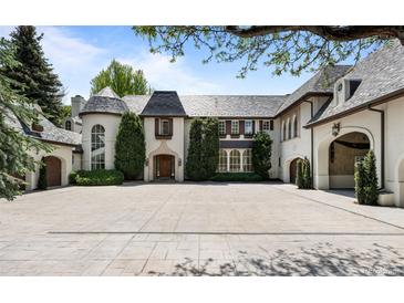 Stately home featuring a circular driveway and manicured landscaping at 5 Churchill Dr, Cherry Hills Village, CO 80113