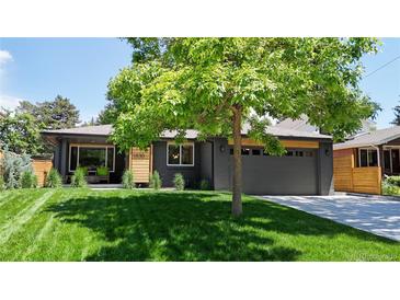 Charming single-story home featuring a freshly manicured lawn and a two-car garage at 1830 S Fillmore St, Denver, CO 80210