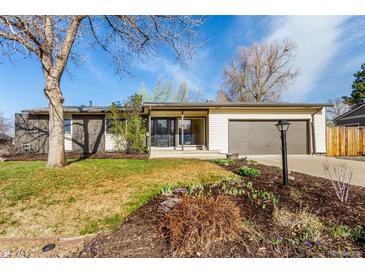 Charming ranch-style home with a well-manicured front yard and attached garage at 6052 Taft St, Arvada, CO 80004
