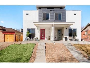 Modern townhome featuring a contemporary design, light stucco, and eye-catching red door and a gray door at 1333 Raleigh St, Denver, CO 80204