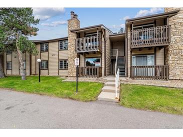 Charming condo exterior with stone accents, balconies, and well-maintained landscaping at 1777 S Pitkin St # A, Aurora, CO 80017