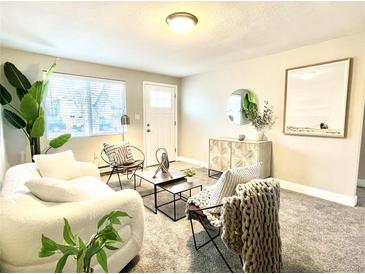Bright living room with a large window, plush seating, and stylish decor at 4816 W 8Th Ave, Denver, CO 80204