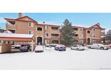 Snow-covered condo building with parking at 8457 S Hoyt Way # 206, Littleton, CO 80128